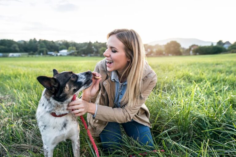 woman with dog in field