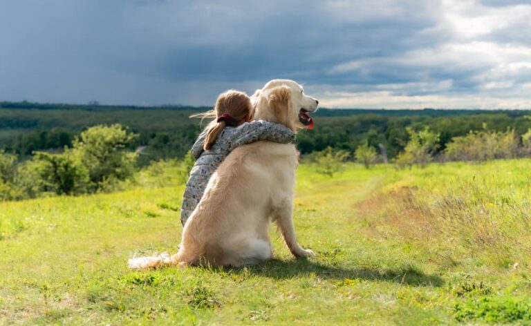 woman with arm around dog