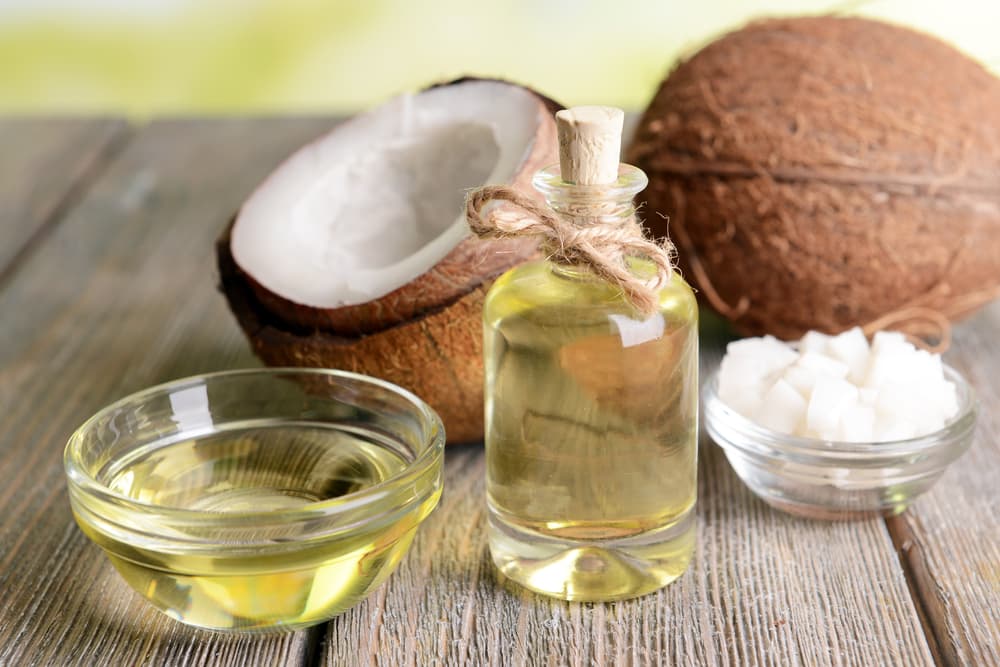 Coconut Oil with coconut on table