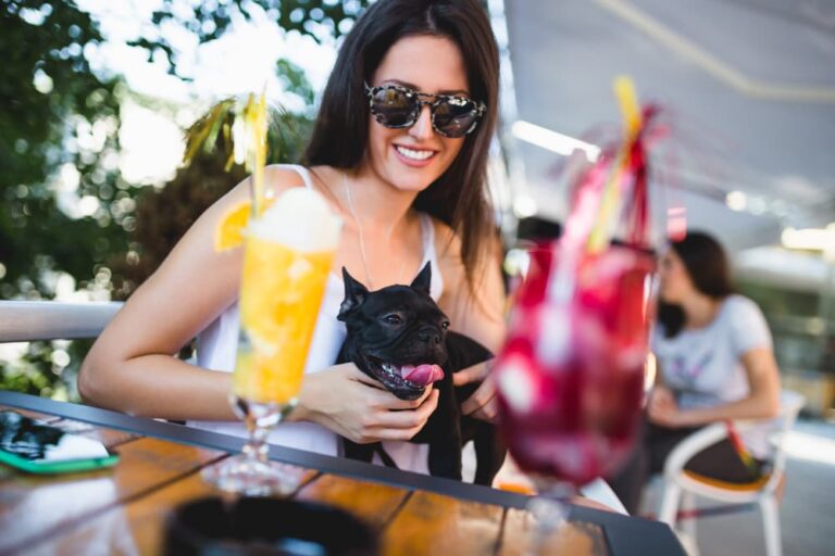 Woman eating at restaurant with dog