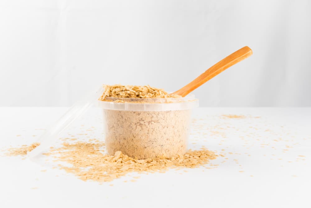 Container of brewer's yeast on table